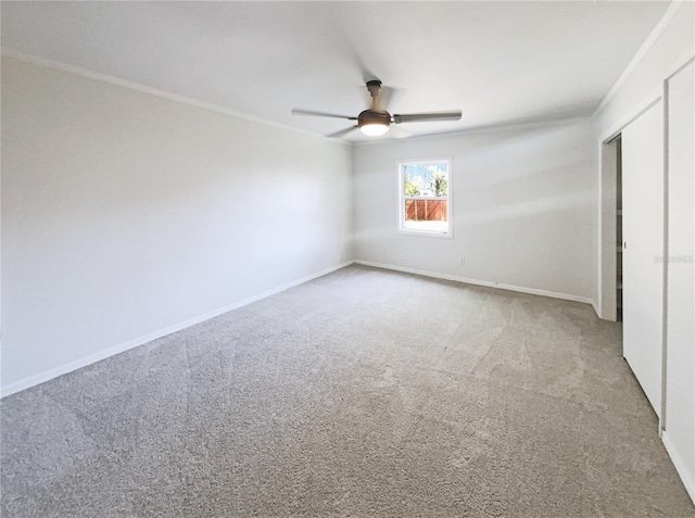 unfurnished bedroom with baseboards, carpet flooring, and ornamental molding