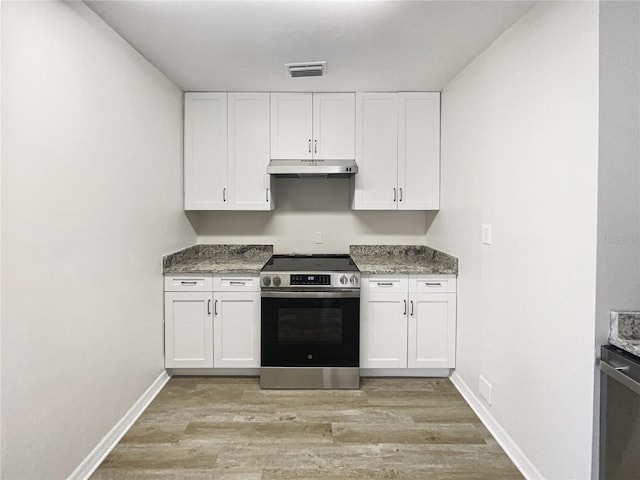 kitchen featuring visible vents, white cabinets, stainless steel electric range, light wood-type flooring, and under cabinet range hood