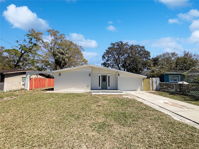 mid-century home with a front lawn and fence