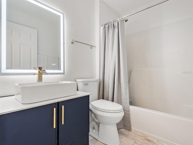 bathroom featuring toilet, shower / tub combo, wood finished floors, and vanity