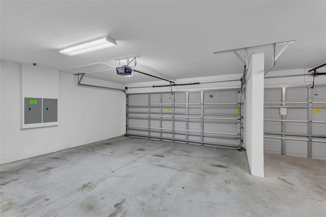 garage featuring electric panel and a garage door opener