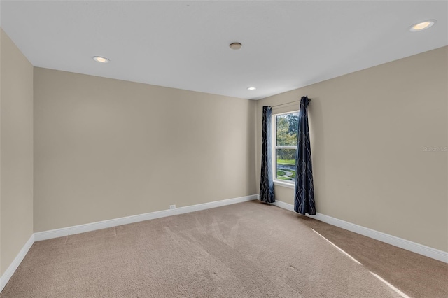 carpeted spare room with recessed lighting and baseboards