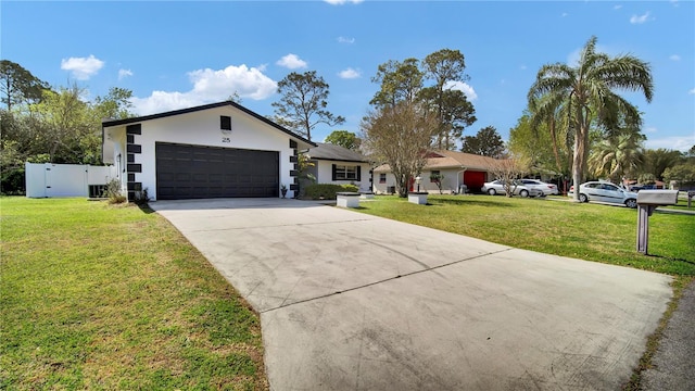 single story home with an attached garage, stucco siding, concrete driveway, and a front yard