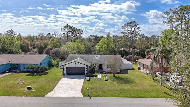 view of front of property featuring a garage, a front yard, and driveway