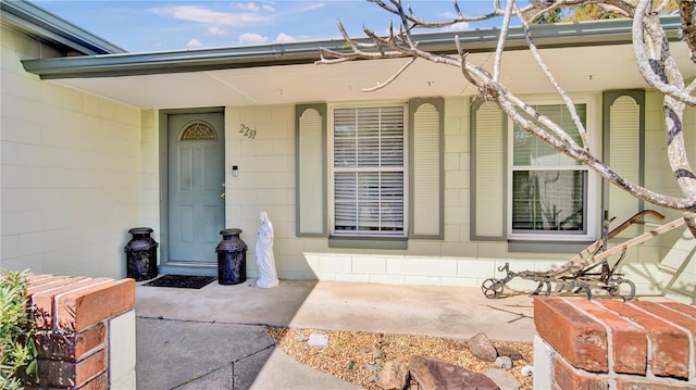 view of exterior entry with concrete block siding