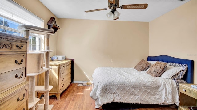 bedroom featuring light wood-style floors, ceiling fan, and baseboards