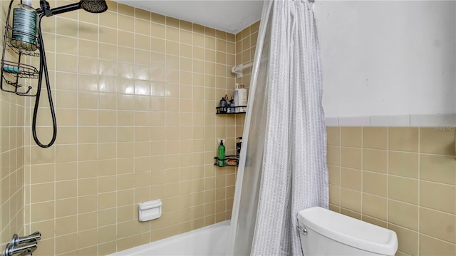 full bathroom with shower / bath combo, tile walls, and toilet