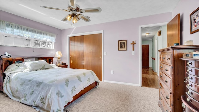 bedroom featuring carpet floors, a closet, ceiling fan, and baseboards