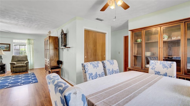 dining room with visible vents, ceiling fan, baseboards, and wood finished floors