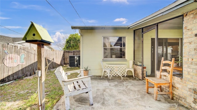 view of patio / terrace with central AC and fence