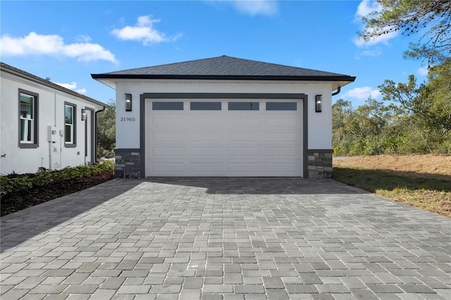 garage with decorative driveway