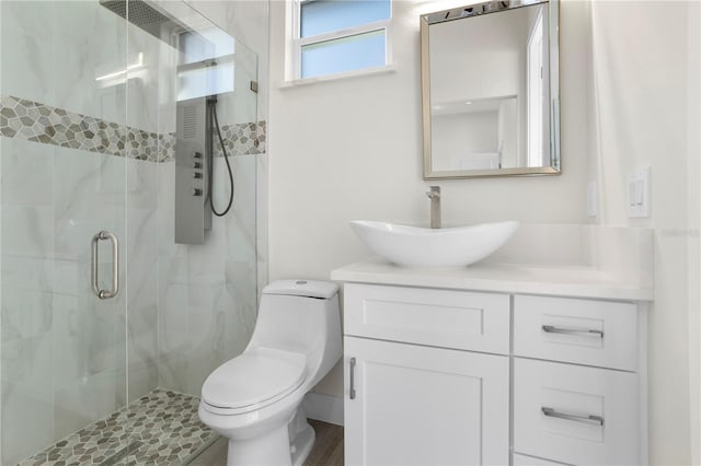 full bath with a shower stall, toilet, and vanity