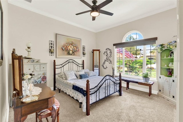 bedroom featuring light carpet, visible vents, baseboards, a ceiling fan, and crown molding