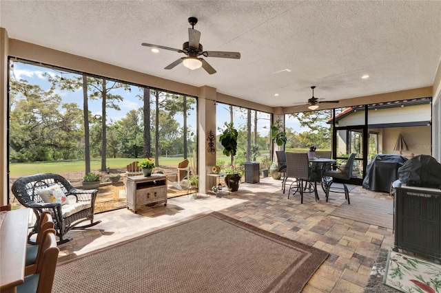 sunroom featuring ceiling fan