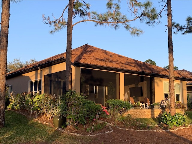 rear view of property featuring a patio area and stucco siding