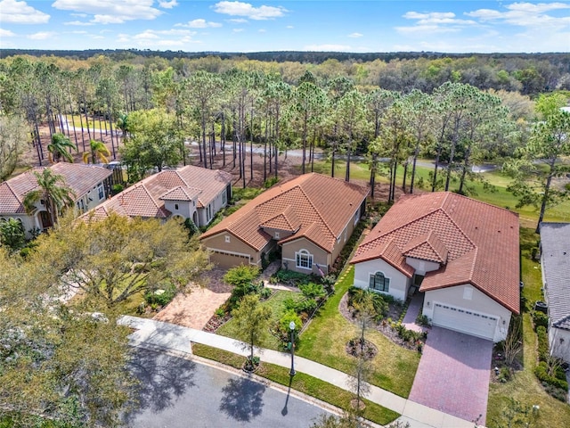 drone / aerial view with a forest view and a residential view