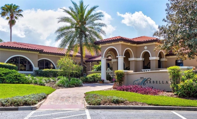 view of building exterior with decorative driveway