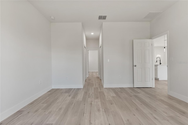 unfurnished bedroom featuring light wood-type flooring, visible vents, and baseboards