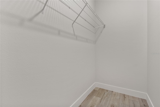 spacious closet with light wood finished floors