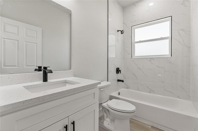 bathroom featuring  shower combination, vanity, toilet, and wood finished floors