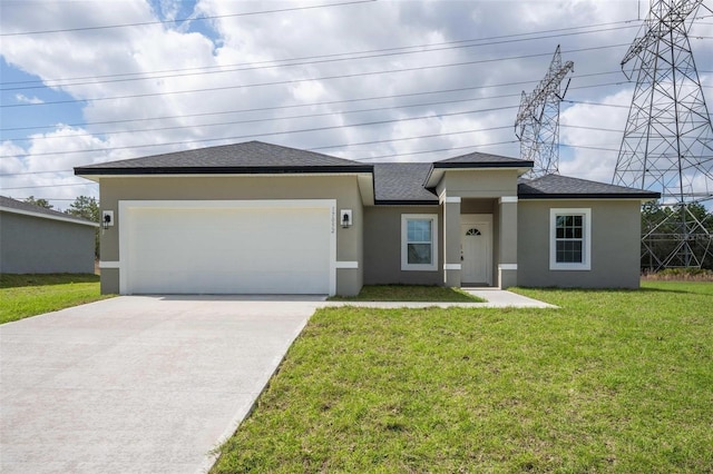 view of front of property with an attached garage, driveway, roof with shingles, stucco siding, and a front yard