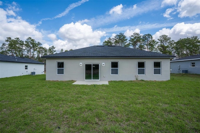 back of property featuring central AC unit, a lawn, and a patio