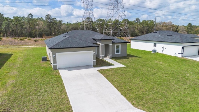 ranch-style home with driveway, central AC unit, an attached garage, a front lawn, and stucco siding