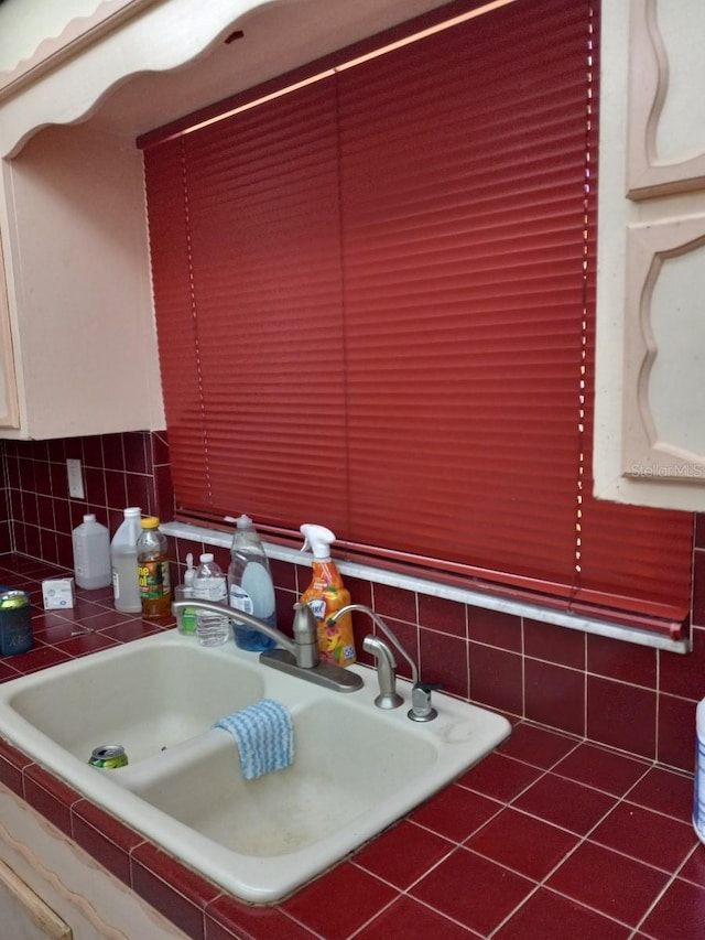 interior space featuring tasteful backsplash, a relaxing tiled tub, and a sink