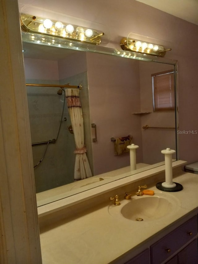 full bath with vanity and a shower with shower curtain