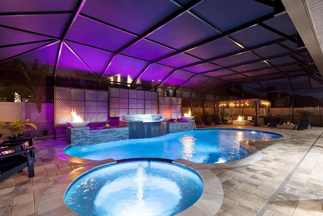 view of swimming pool with glass enclosure, a patio area, a pool with connected hot tub, and fence