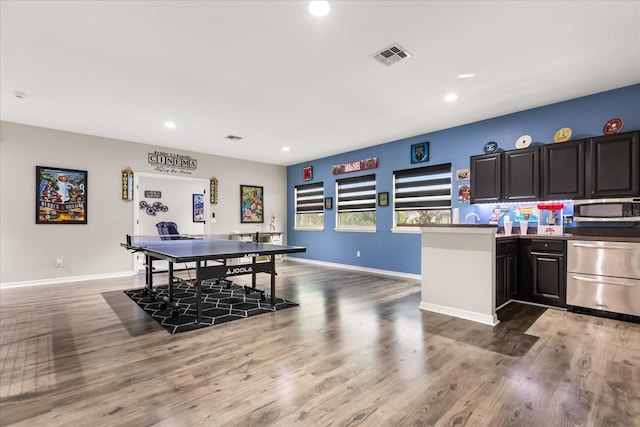 interior space featuring recessed lighting, wood finished floors, visible vents, and baseboards