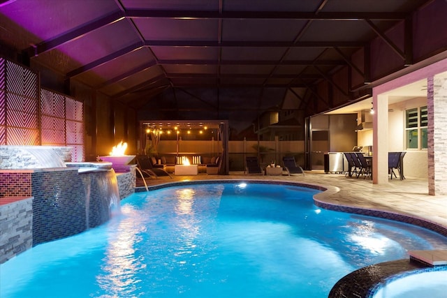 view of swimming pool featuring a patio area, a lanai, and a pool with connected hot tub