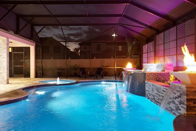 view of swimming pool featuring glass enclosure, a patio area, a fenced in pool, and an in ground hot tub