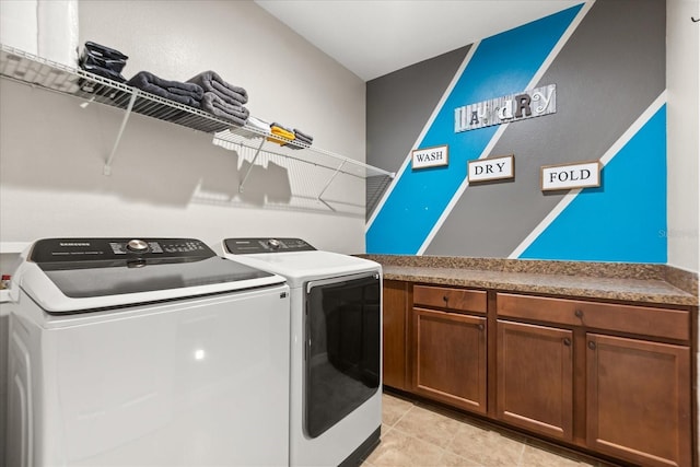 washroom with light tile patterned flooring and washing machine and clothes dryer