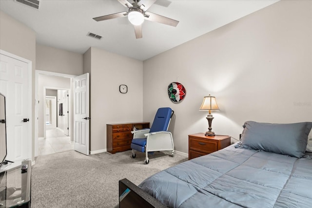 carpeted bedroom featuring baseboards, visible vents, and a ceiling fan