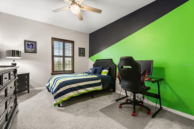 carpeted bedroom with a ceiling fan and baseboards