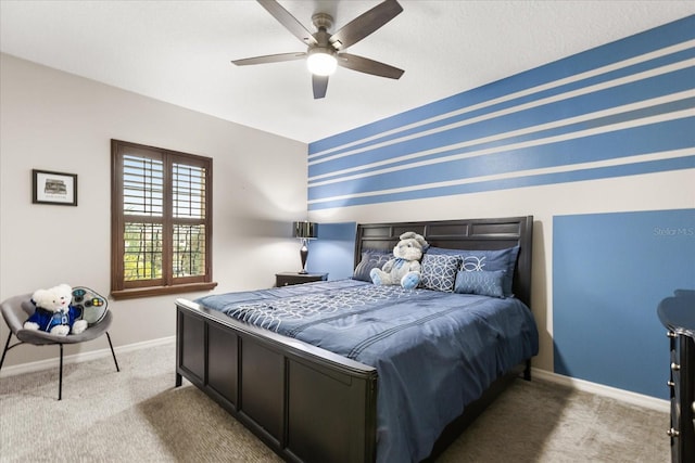 carpeted bedroom featuring ceiling fan and baseboards