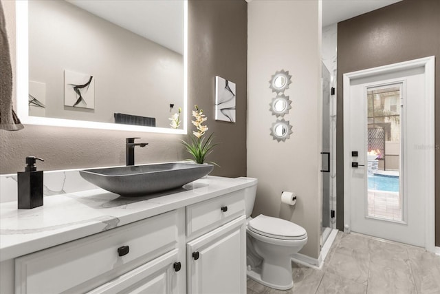 full bathroom with toilet, a stall shower, marble finish floor, and vanity