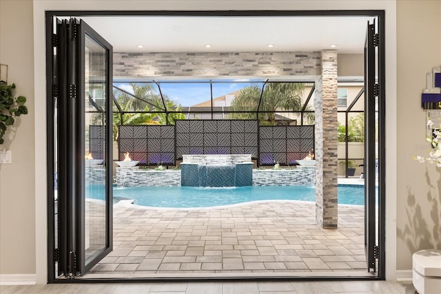 view of swimming pool with a patio, a lanai, and a fenced in pool