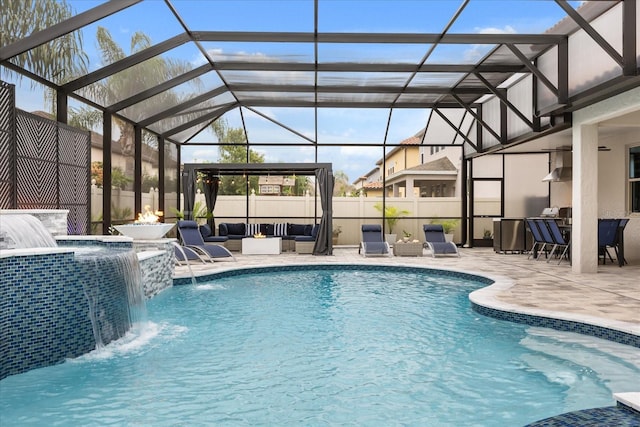 view of swimming pool featuring a lanai, fence, a fenced in pool, a patio area, and an outdoor living space with a fire pit