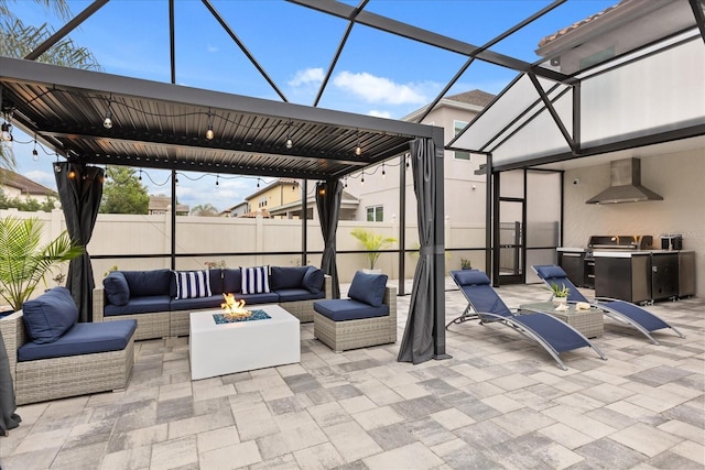 view of patio / terrace with a lanai, outdoor lounge area, fence, and area for grilling