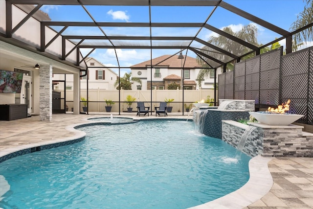 view of swimming pool with a patio, glass enclosure, fence, and a fenced in pool