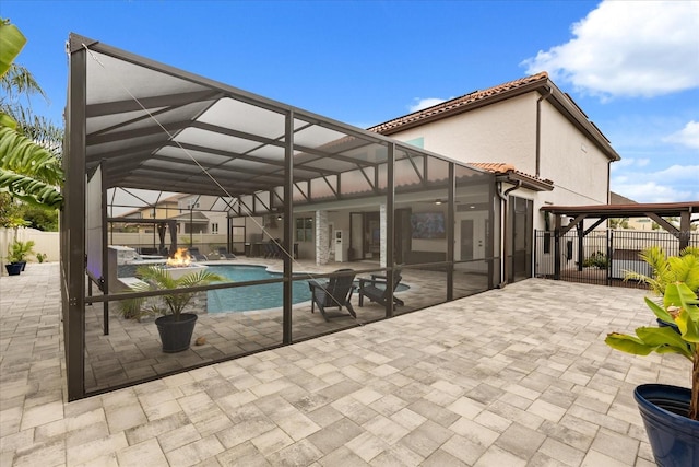 view of pool with a lanai, a patio area, fence, and a fenced in pool