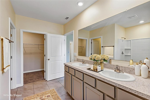 39 Hickory Course Way, Ocala, FL 34472 - bathroom featuring double vanity, a walk in closet, and tile patterned floors