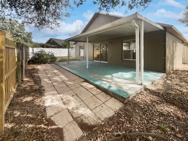 back of property with a patio area, a fenced backyard, and stucco siding