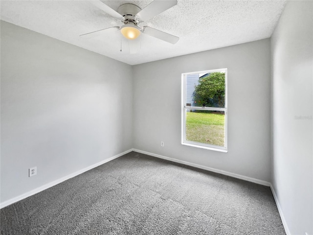 carpeted spare room featuring ceiling fan, a textured ceiling, and baseboards