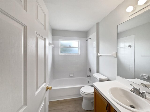 bathroom featuring shower / tub combination, vanity, toilet, and wood finished floors