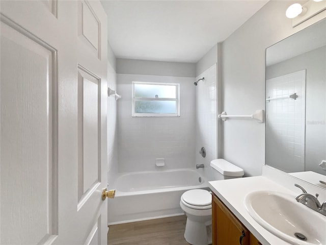 bathroom with shower / washtub combination, vanity, toilet, and wood finished floors