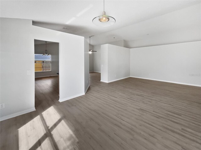 interior space featuring a ceiling fan, baseboards, and wood finished floors