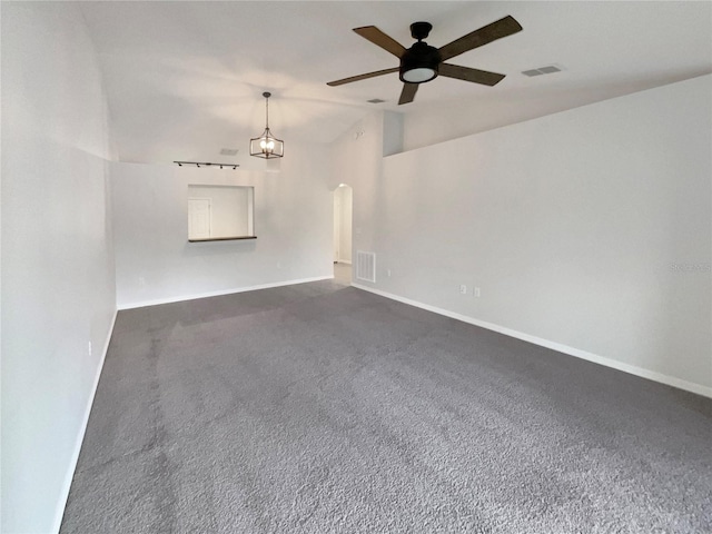 unfurnished room featuring lofted ceiling, arched walkways, ceiling fan with notable chandelier, visible vents, and baseboards